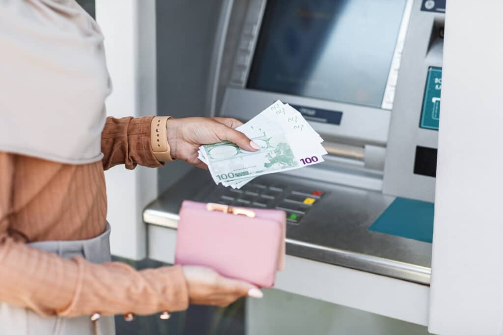 cropped young arab lady holds a lot of euros and a wallet