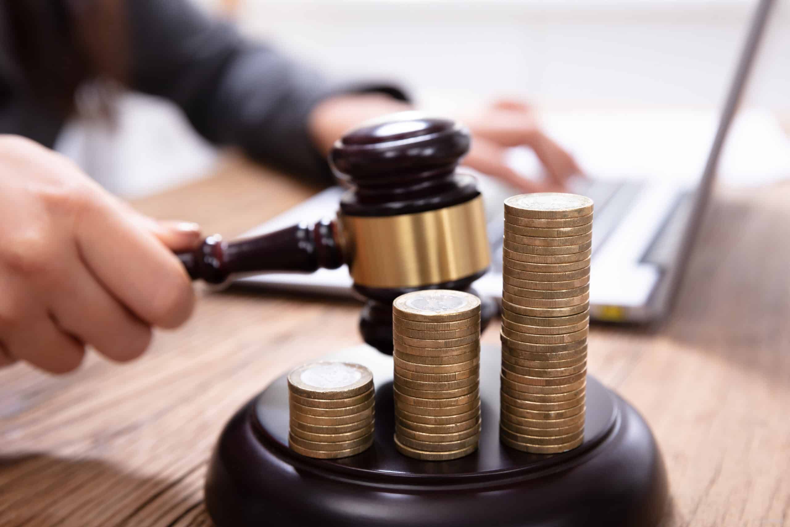 stack of increasing coins on gavel at workplace