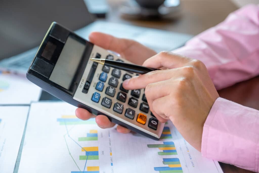 businessmen bookkeeper hand use calculator and laptop doing acco