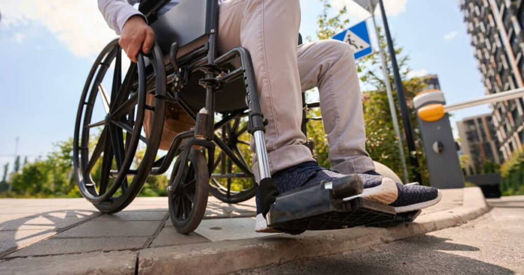 disabled man going down curb in manual wheelchair