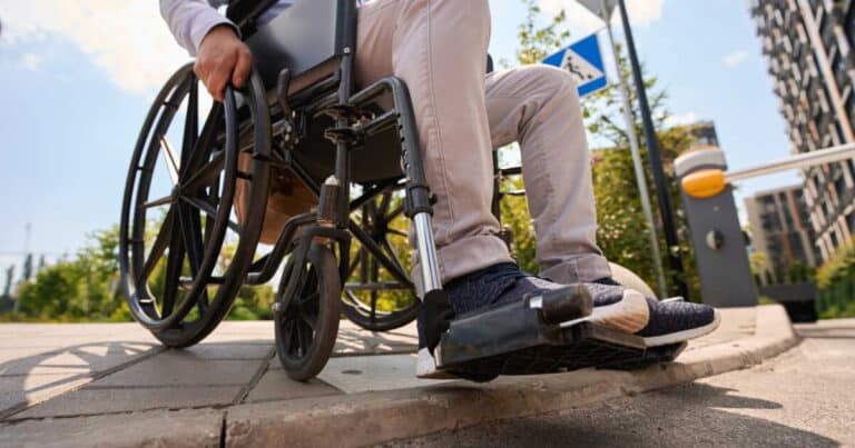 disabled man going down curb in manual wheelchair