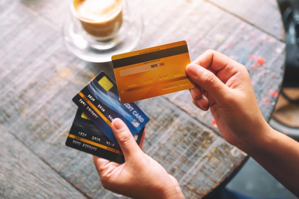 top view image of a woman holding and showing credit cards