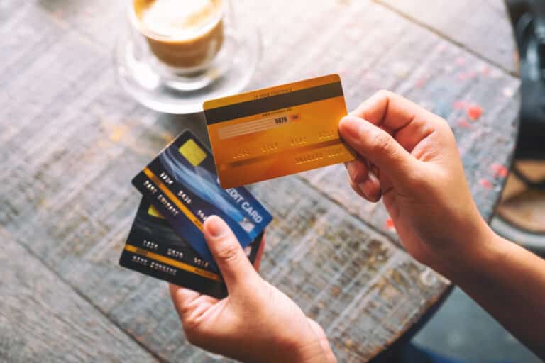 top view image of a woman holding and showing credit cards