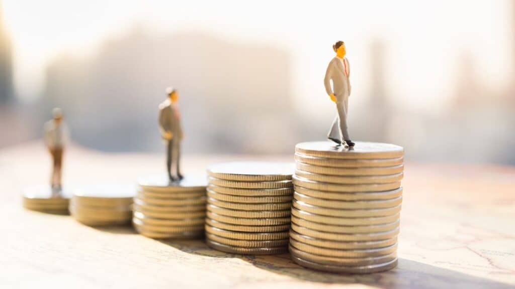 miniature,people:,small,figure,standing,on,stack,of,coin.,money